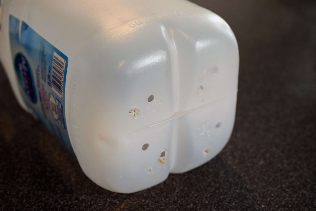 Holes punched in the bottom of water jug