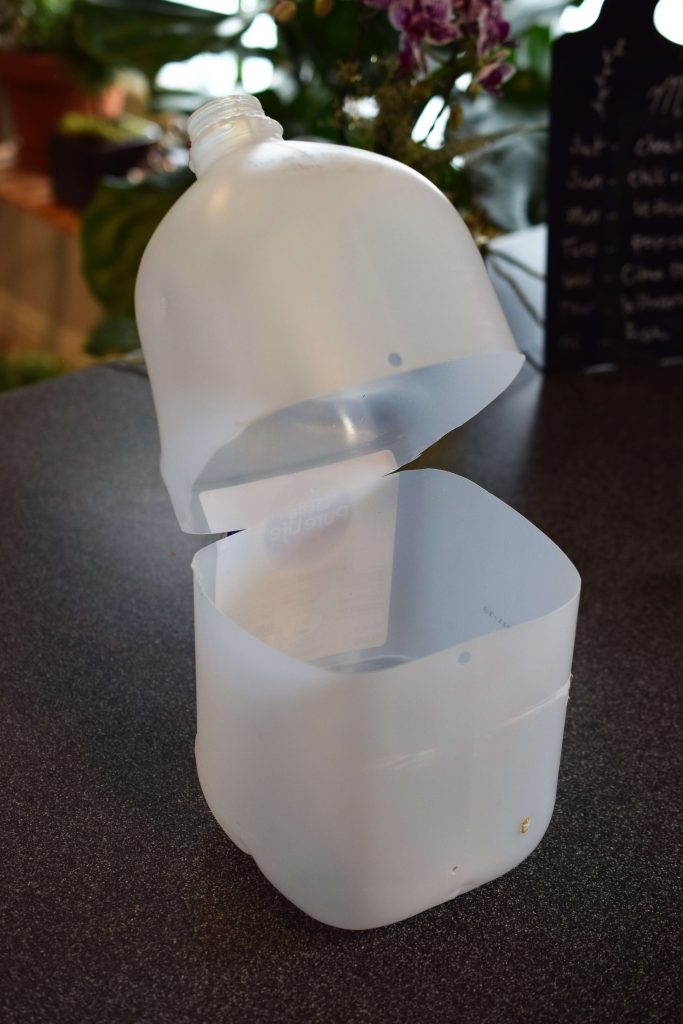 Water jug with hole punch for sealing