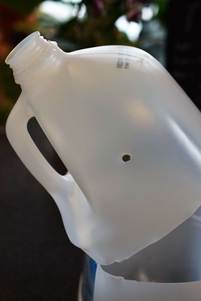 Water jug with cut with hinge under handle